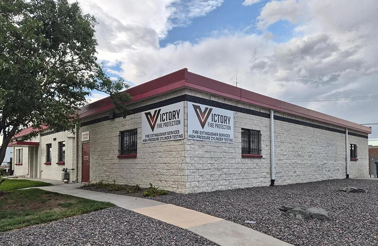 Exterior commercial signs for Victory Fire Protection mounted on the side of a commercial building.