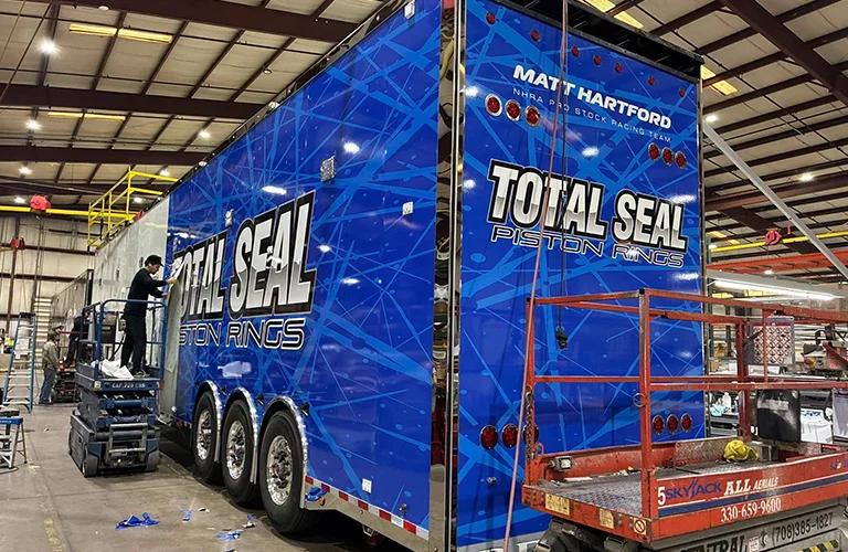 Fleet vehicle wrap on a large Total Seal Piston Rings racing trailer.