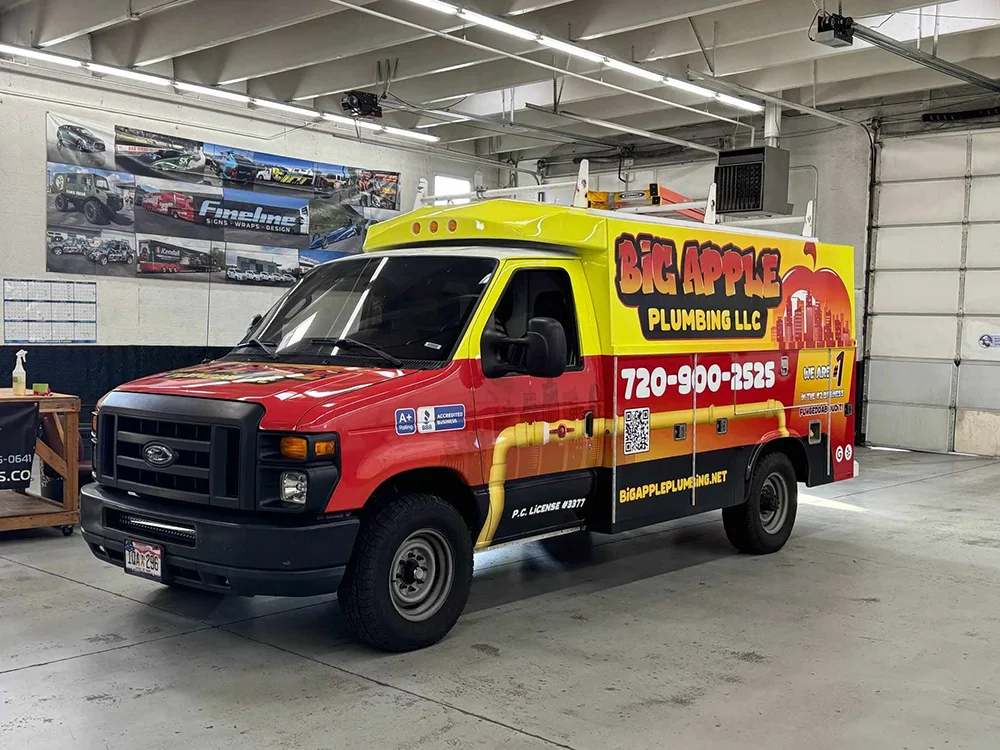 Vehicle wrap design for Big Apple Plumbing LLC featuring bold red, yellow, and black graphics, company contact information, service details, and a QR code applied to a commercial service van.