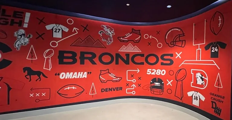 Custom Denver Broncos wall graphic featuring team colors, football icons, play diagrams, jerseys, and Broncos branding.